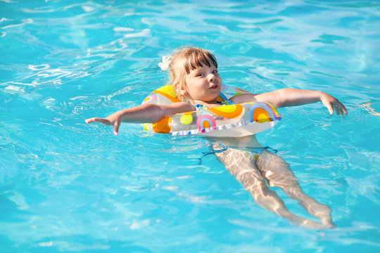 Happy little girl in the pool