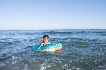 Boy floating in the sea in the float