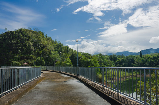 pathway on top of dam for overlooking the water and mountains
