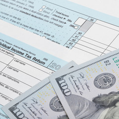 USA Tax Form 1040 with 100 US dollar bills - 1 to 1 ratio