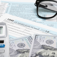 USA Tax Form 1040 with calculator and US dollars - 1 to 1 ratio