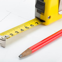 Tape measure with pencil above blueprint - 1 to 1 ratio