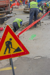 Fototapeta na wymiar Traffic sign for construction works in street and workers 2