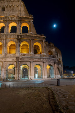 Colosseum by night with moon