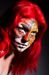 Woman with tiger face in halloween concept