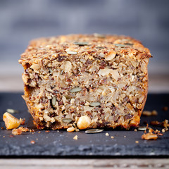 Wholegrain bread with seeds on a stone plate