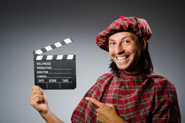 Funny scotsman with movie clapboard