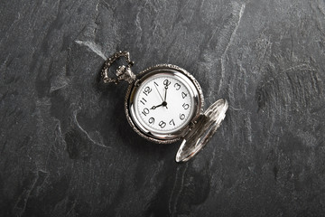 Pocket gray clock on dark gray