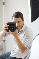 Fototapeta premium Photographer in studio with lighting equipment
