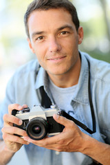 Photographer shooting outside with old camera