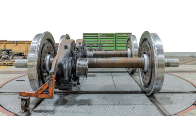 Spare railway wheels on the axle in a repair workshop on isolate - obrazy, fototapety, plakaty