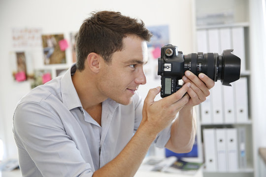 Portrait of photographer taking pictures in studio