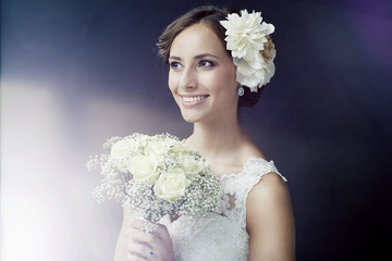 Stunning young bride holding bouquet.
