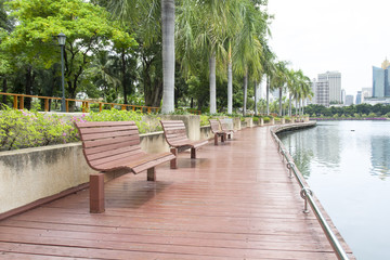 Bench in city park gardens of Bangkok, Thailand