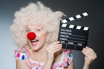 Clown with movie clapper board