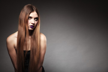 Sad unhappy girl young woman with long hair and creative makeup