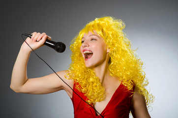 Young woman with mic in music concept