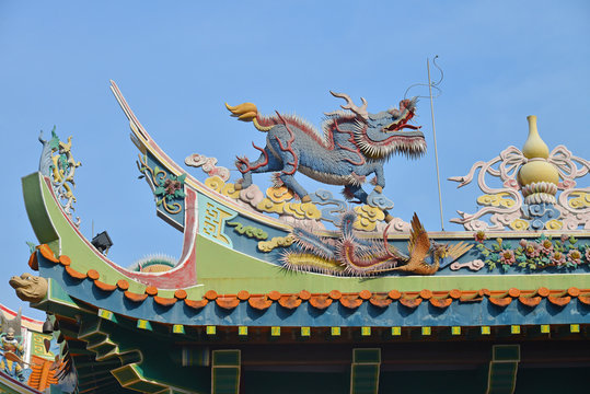 Kirin And Phoenix Statues On The Roof Of A Chinese Temple