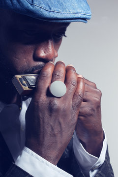 musician plays the harmonica