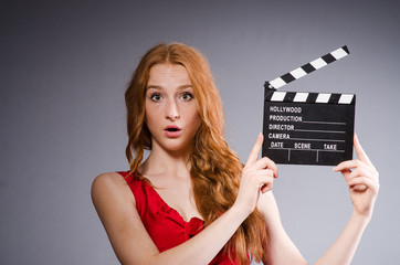 Woman in red dress with movie board
