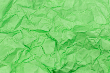 Green crumpled paper texture background.