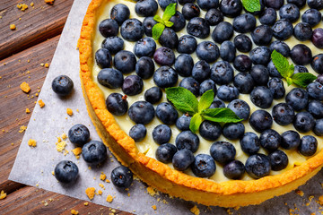 Blueberry Tart on vintage wooden background