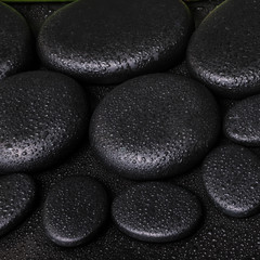 Obraz na płótnie Canvas spa concept of zen basalt stones with dew, closeup