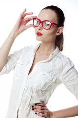 Business woman in glasses and a bright white shirt on a white ba