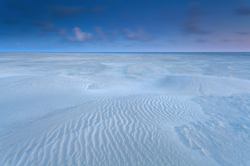 Fototapeta na wymiar sand dunes on North sea coast at sunrise