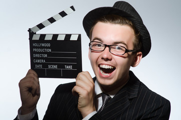 Man with movie clapperboard and hat