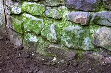 Green Moss Covering Curved Stone Retaining Wall