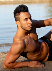 Fototapeta na wymiar Handsome muscular man on the beach.