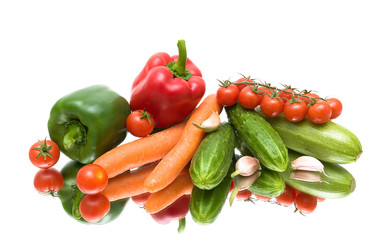 Vegetables on the mirror surface. white background.