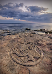 sea-coast with ancient pictographs on the rocks