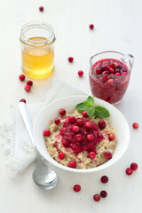 Oatmeal with cranberry jam, fresh cranberries and honey