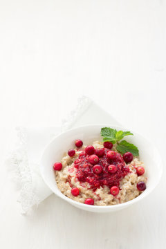 Oatmeal with cranberry jam, fresh cranberries and honey