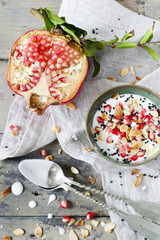 pomegranate and white yogurt with grains and almonds