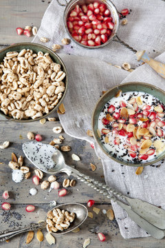 pomegranate and white yogurt with grains and almonds