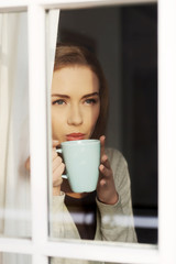 Beautiful caucasian woman drinking hot coffee