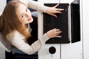 Young woman using a laptop computer at home