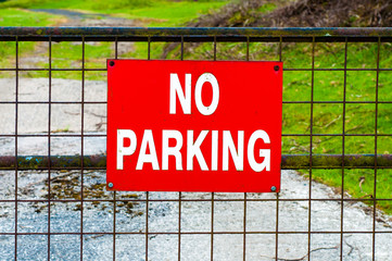 Closeup on red NO PARKING sign