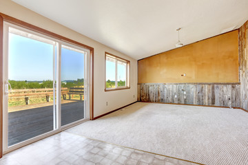 Empty countryside house interior. Orange wall with wooden plank