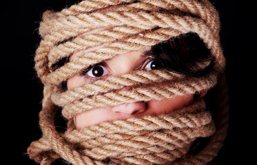Tied up scared woman face.