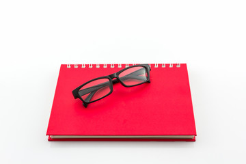 Red Diary Book with old glasses.