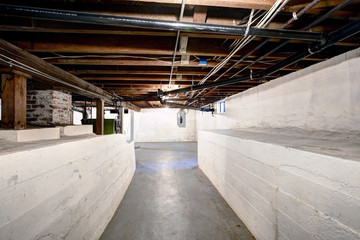 Empty basement in old house with white walls