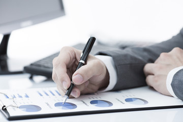 Businessman analyzing investment charts with computer. Accountin