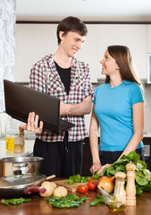 Smiling man shows the new recipe to girl