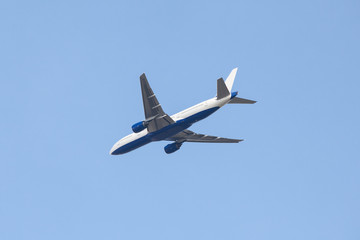 Fototapeta na wymiar Aircraft flying in blue sky