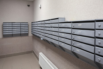 Boxes for letters are in the lobby of an apartment house