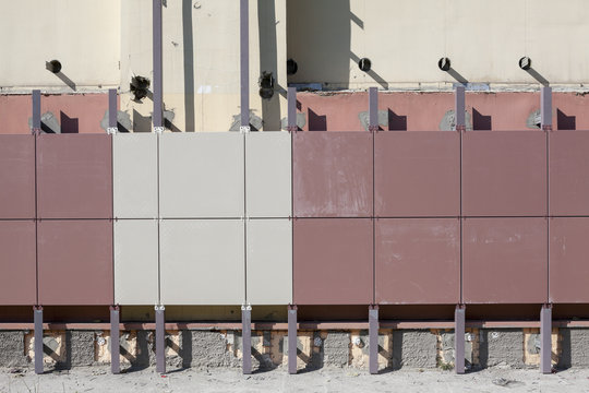 Installation of ventilated facades with tiles of building wall